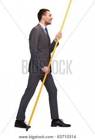 business and advertisement concept - smiling busnessman holding flagpole with imaginary flag