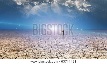 Wanderer on dried desert mud