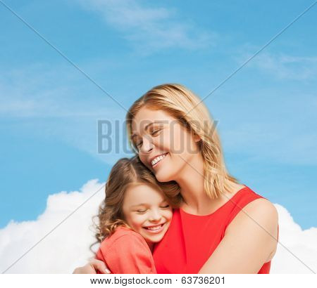 family, child and happiness concpt - hugging mother and daughter