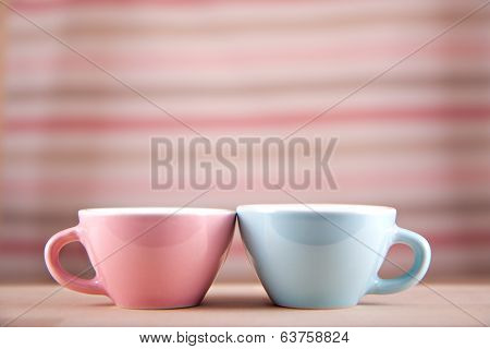 couple cups of soft background symbol for men and women