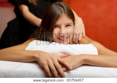 Young woman receiving a massage in a spa
