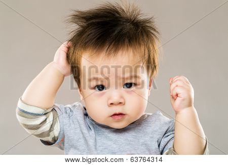 Asian serious kid with grey background