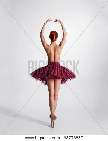 Young beautiful ballet dancer isolated over white background