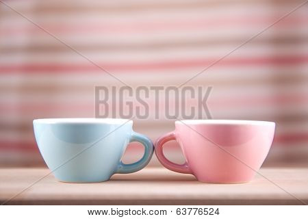 couple cups of soft background symbol for men and women