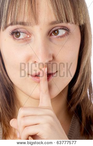 Attractive woman with finger on lips