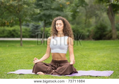 Pretty woman doing yoga exercises