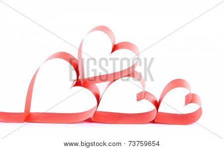 Heart shaped red paper ribbon isolated on white