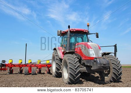 Tractor sowing and cultivating field