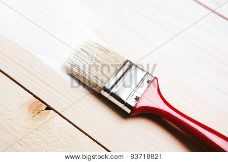 Varnishing a wooden shelf