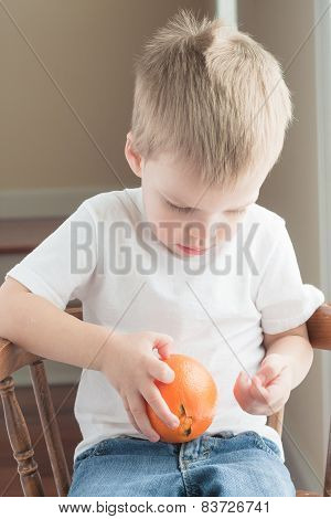 toddler peeling orange