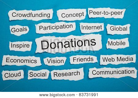 Word Donations On Piece Of Torn Paper