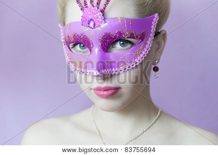 woman in pink carnival mask.