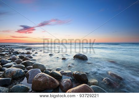 Sunset Over The Baltic Sea. The Pebbly Beach In Rozewie
