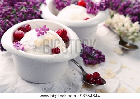 Beautiful composition with tasty ice cream and lilac flowers