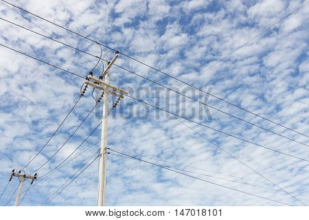 an electric pole on blue sky day