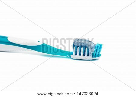 toothbrush with toothpaste on a white background
