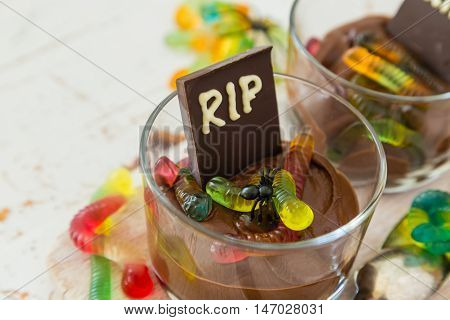 Chocolate mousse with gelly worm with halloween decorations