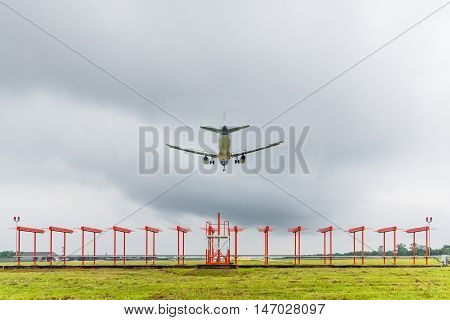 Airplane is landing at the airport before storm approaching.