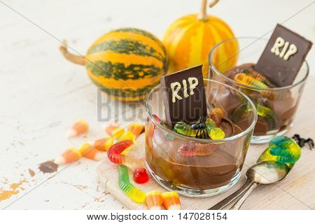 Chocolate mousse with gelly worm with halloween decorations