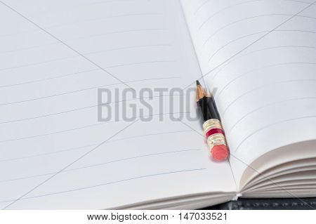 Black Pencil With Pink Eraser On A Paper