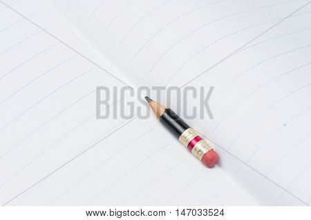 Black Pencil With Pink Eraser On A Paper