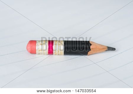 Black Pencil With Pink Eraser On A Paper