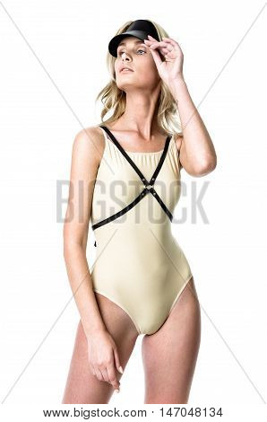 Blonde girl wearing bodysuit and black leather belt and visor