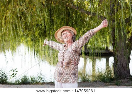 Elder happy woman outside in the nature