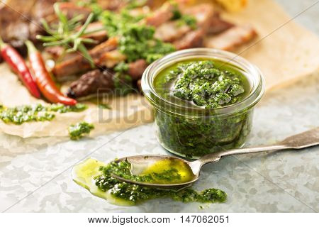 Green chimichurri parsley sauce with grilled steak
