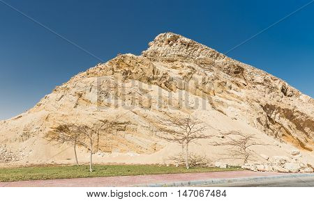 Huge sand mountain next rto road in Egypt