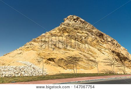 Huge sand mountain next rto road in Egypt