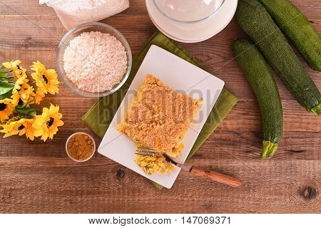 Rice timbale with zucchini on white dish.