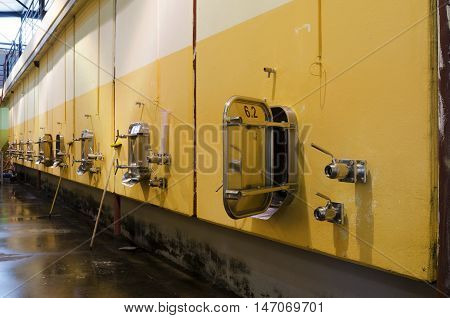 Wall in Bulgarian winery with stainless steel fermentation vessels