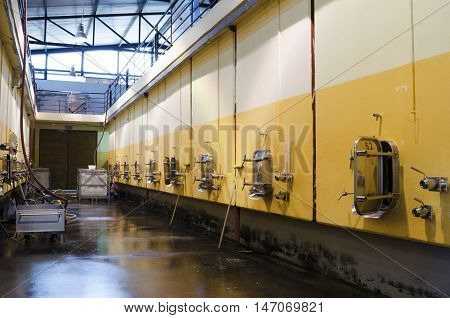Stainless steel fermentation vessels. Cleaning the floor