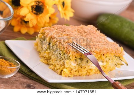 Rice timbale with zucchini on white dish.