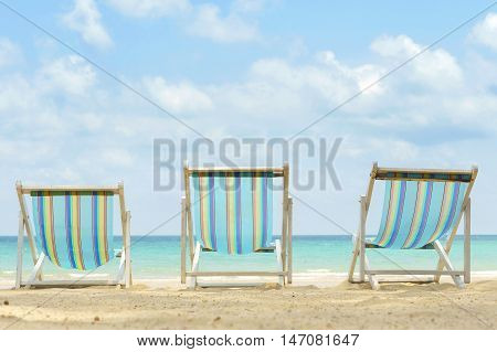 three canvas beach bed on the beach with nice sky and cloud