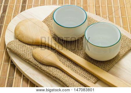 Trencher and cups on the wooden background