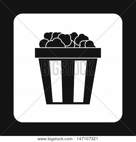 Popcorn in striped bucket icon in simple style on a white background vector illustration