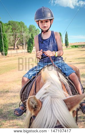 Little boy on the horse. Horseback riding
