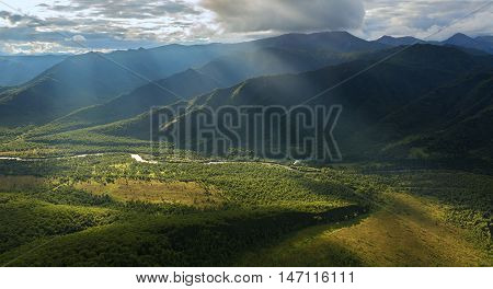 Evening rays on Kronotsky Nature Reserve in Kamchatka Peninsula. View from helicopter.