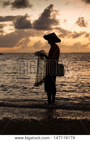 old fisherman in a sea in Bali Indonesia