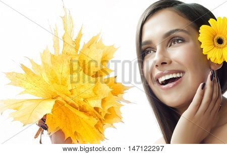closeup portrait of attractive  caucasian smiling woman brunette isolated on white studio shot lips toothy smile face hair  looking at camera tooth hand holding yellow marple autumn leaves