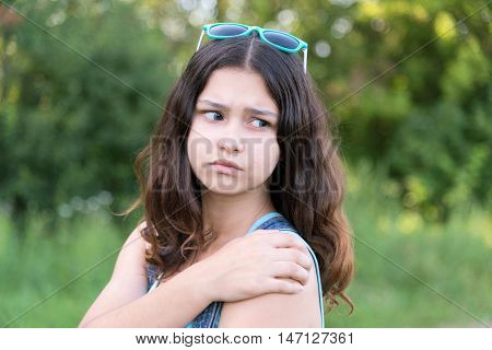 teen girl with health problems in the nature in summer