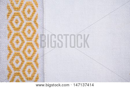 Fragment of hand embroidery on canvas. Background.