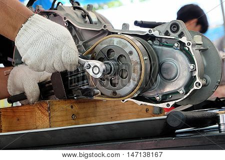 Hands of disassembly kit motorcycle in repair service. Automotive engine disassembly kit motorcycle.