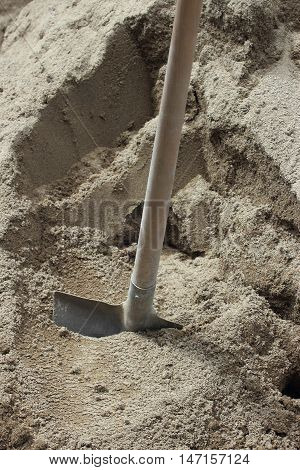 shovel in sand pile on construction site