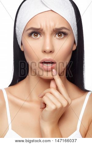 Herpes on the lips of the young woman. Shocked young woman touching pain her lips. Inflammation of the lip. Herpes on the lips, beauty concept. Woman with herpes virus. Woman Skin Care Concept