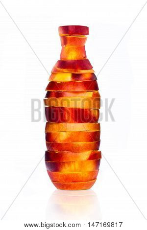 Bottle made from sliced nectarine on white