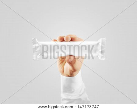 Blank white candy bar plastic wrap mock up holding in hand, clipping path. Clear chocolate bar packaging template. Choco factory logo branding candybar package mock up. Pastry shop energy bar cover