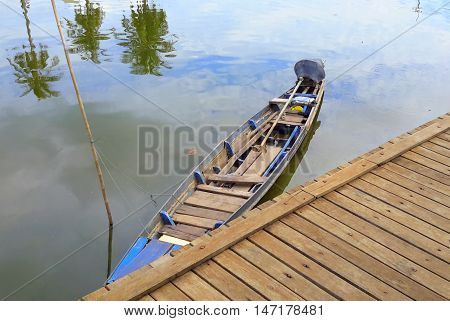 Thai longtail boat tied up at the dock, river water market at Ranot, Thailand